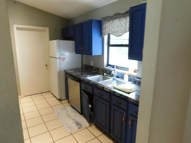 kitchen with dishwasher, sink, white refrigerator, light tile patterned floors, and blue cabinetry