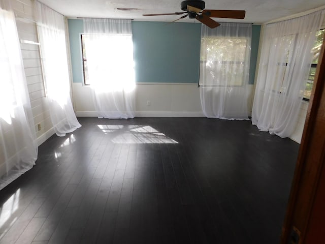 empty room featuring ceiling fan and dark hardwood / wood-style floors