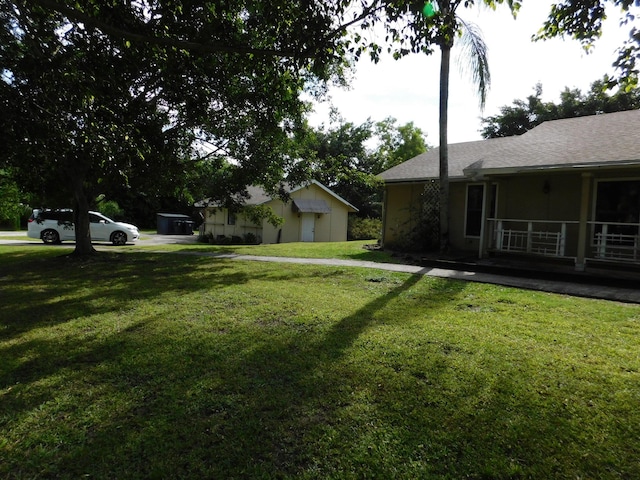 view of yard with covered porch