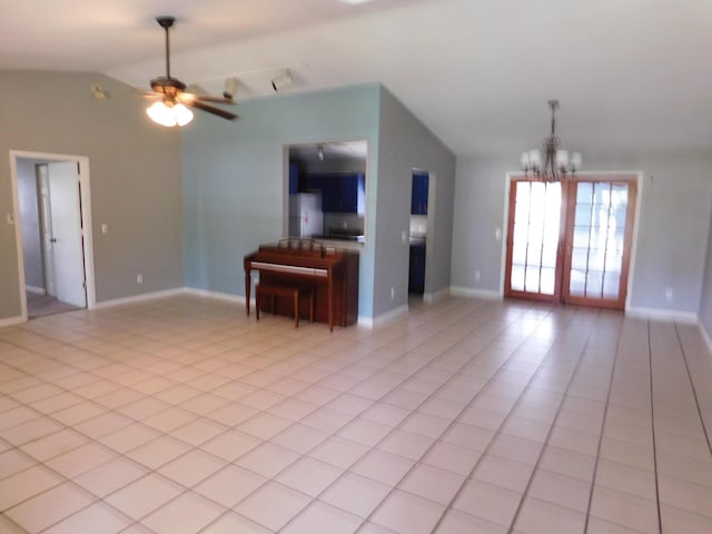 unfurnished living room with ceiling fan with notable chandelier, vaulted ceiling, and light tile patterned flooring