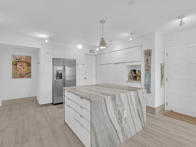 3000 S Ocean Blvd Unit 1504, Boca Raton, FL 33432 - kitchen featuring stainless steel fridge, white cabinetry, light wood-type flooring, and modern cabinets