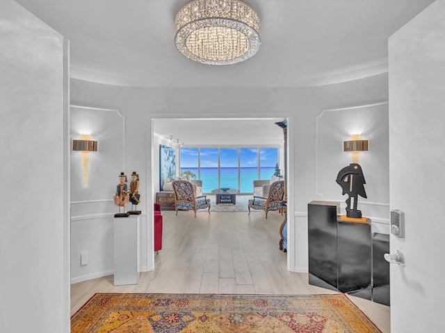 interior space with a notable chandelier and light wood-type flooring