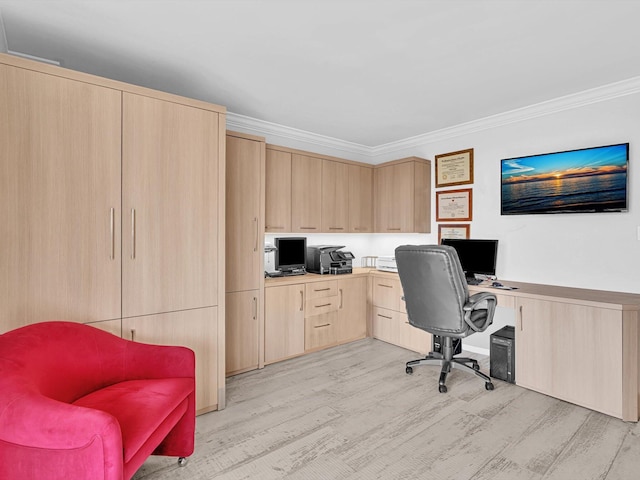 office area with crown molding, built in desk, and light hardwood / wood-style floors