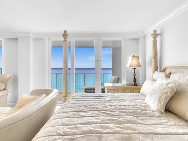 bedroom with a water view, ornamental molding, and access to exterior