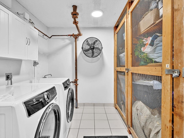 3000 S Ocean Blvd Unit 1504, Boca Raton, FL 33432 - washroom with cabinet space, washing machine and clothes dryer, and light tile patterned floors