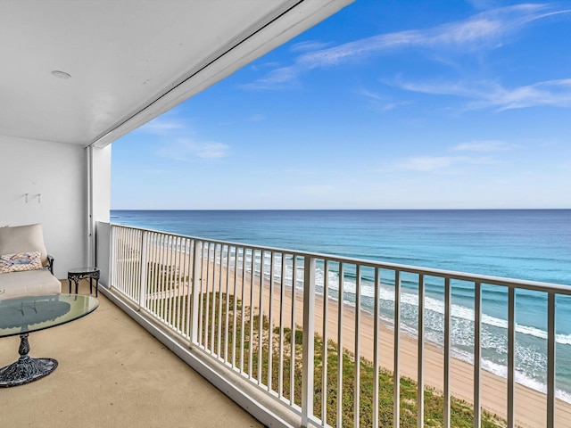 balcony featuring a water view and a beach view