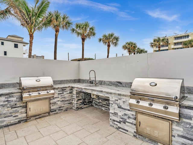 view of patio with a grill and an outdoor kitchen