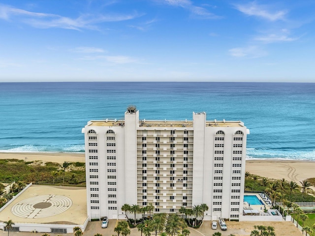 drone / aerial view featuring a water view and a beach view