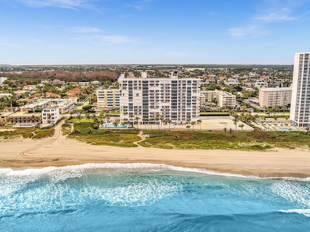 bird's eye view with a water view and a beach view