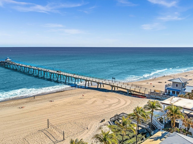 bird's eye view with a water view and a beach view