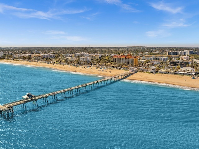 birds eye view of property with a beach view and a water view