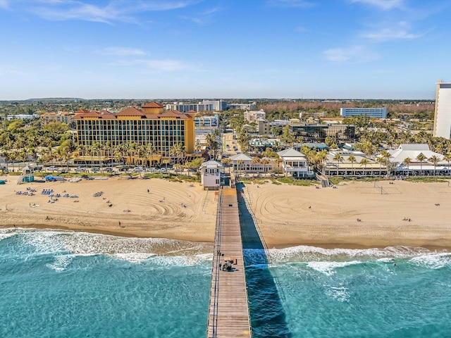 drone / aerial view featuring a water view and a beach view