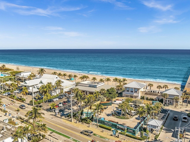 drone / aerial view featuring a water view and a beach view