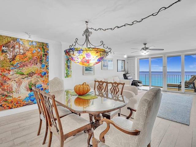 3000 S Ocean Blvd Unit 1504, Boca Raton, FL 33432 - dining area featuring a water view, crown molding, ceiling fan, and light wood-style floors