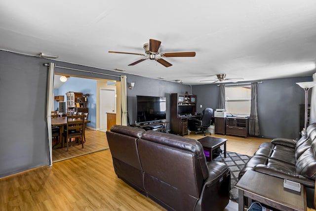 living room with light hardwood / wood-style floors and ceiling fan