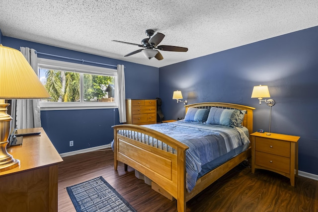 bedroom with dark hardwood / wood-style flooring, ceiling fan, and a textured ceiling