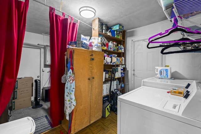 clothes washing area featuring dark parquet flooring, washer and clothes dryer, and a textured ceiling