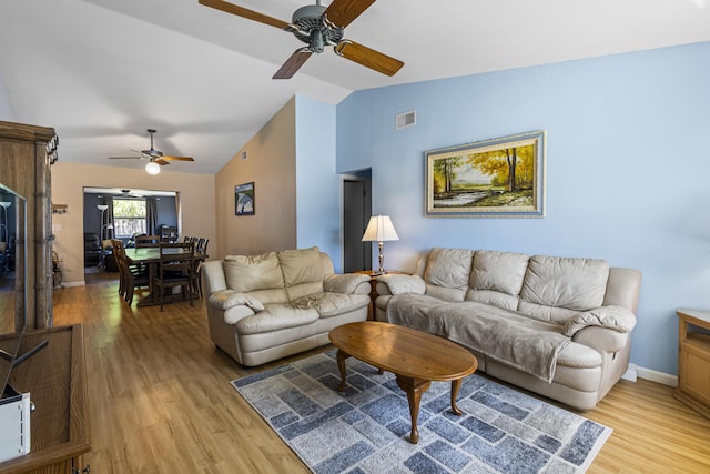 living room with vaulted ceiling and light hardwood / wood-style flooring