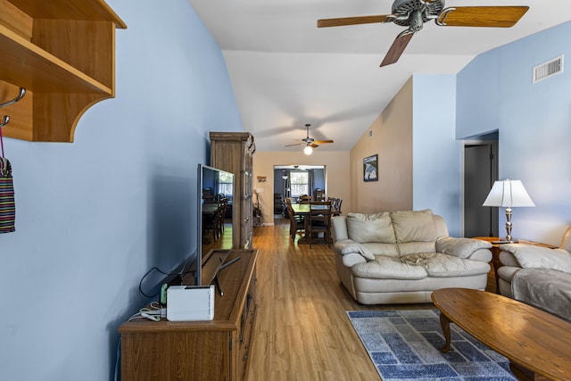 living room featuring lofted ceiling, light hardwood / wood-style floors, and ceiling fan