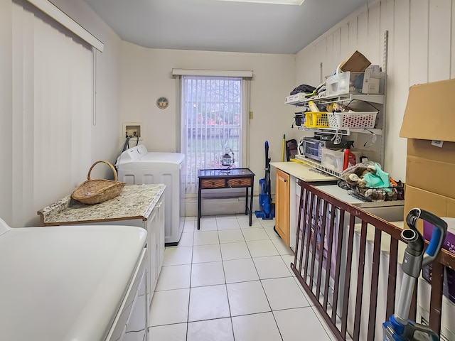 washroom with washing machine and dryer and light tile patterned flooring