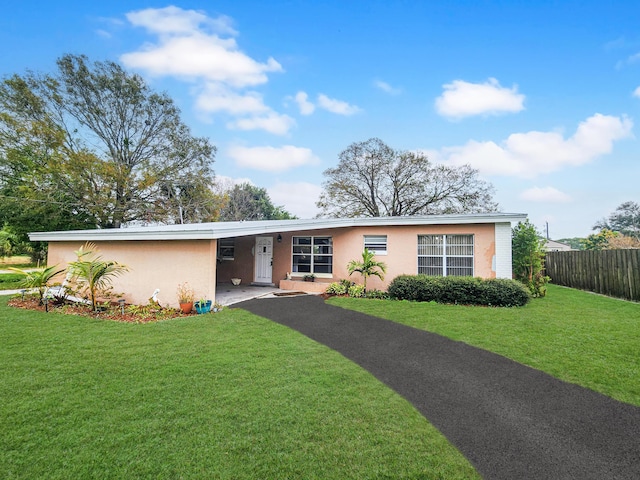 ranch-style home with a front lawn