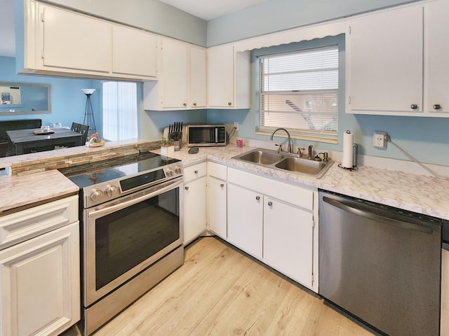 kitchen featuring stainless steel appliances and white cabinets