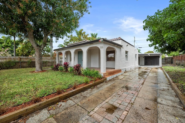 mediterranean / spanish-style house with a front lawn