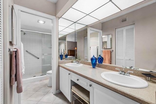 bathroom featuring vanity, an enclosed shower, tile patterned floors, and toilet