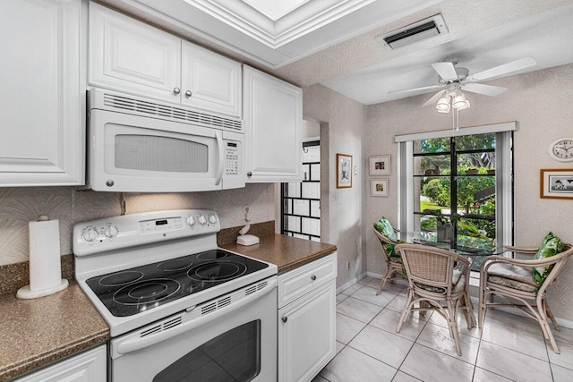 kitchen with ceiling fan, light tile patterned floors, white cabinets, and white appliances