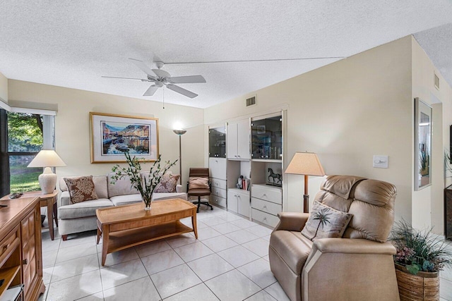 tiled living room featuring ceiling fan and a textured ceiling