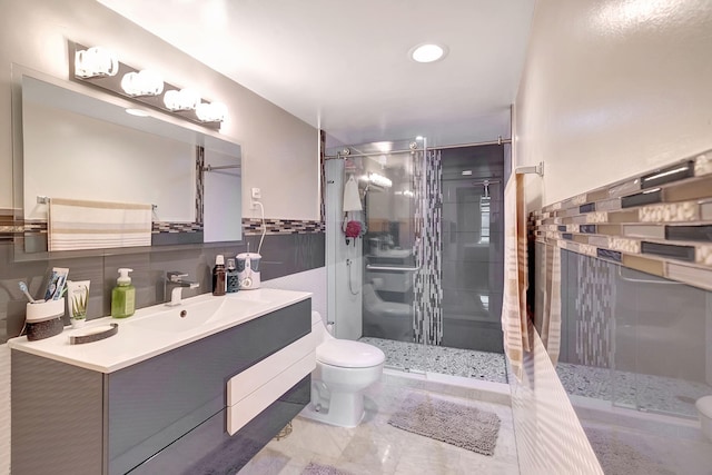 3600 NE 170th St Unit 407, North Miami Beach, FL 33160 - full bathroom with a wainscoted wall, toilet, vanity, tile walls, and a stall shower