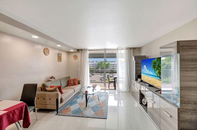 living room with floor to ceiling windows and light tile patterned flooring