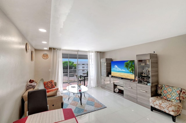 tiled living room featuring a wall of windows