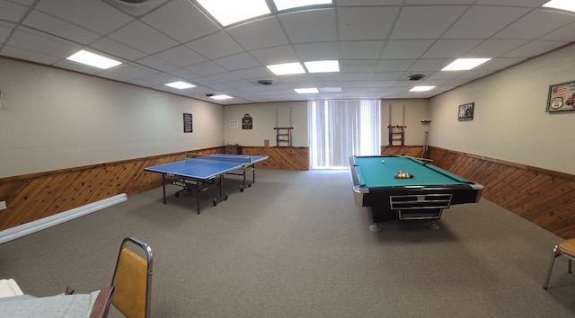 recreation room with carpet and a paneled ceiling