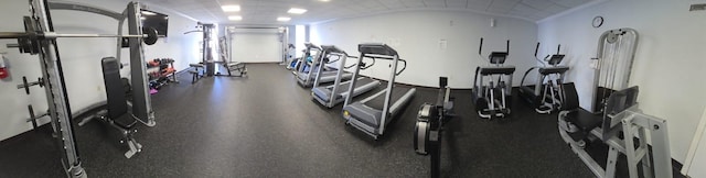 workout area featuring lofted ceiling and brick ceiling