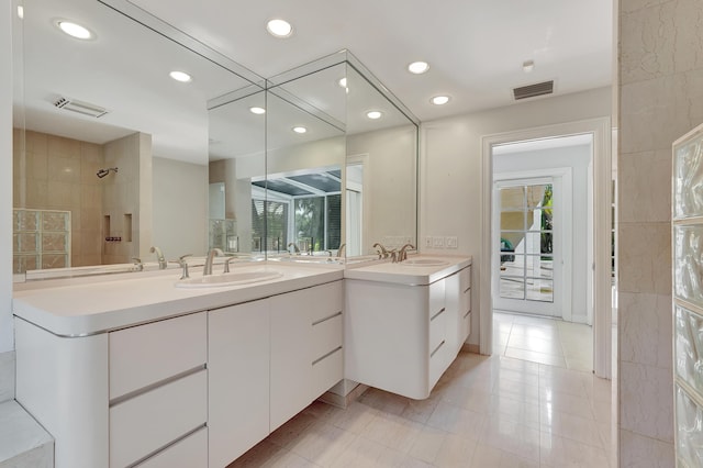 bathroom with vanity, a wealth of natural light, and walk in shower