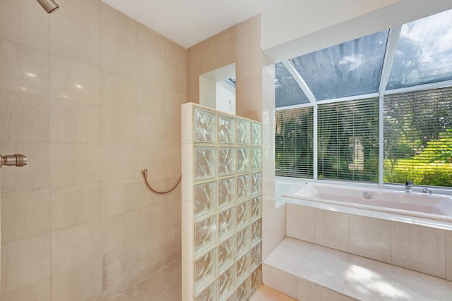 bathroom with tiled shower, tile walls, and tile patterned flooring