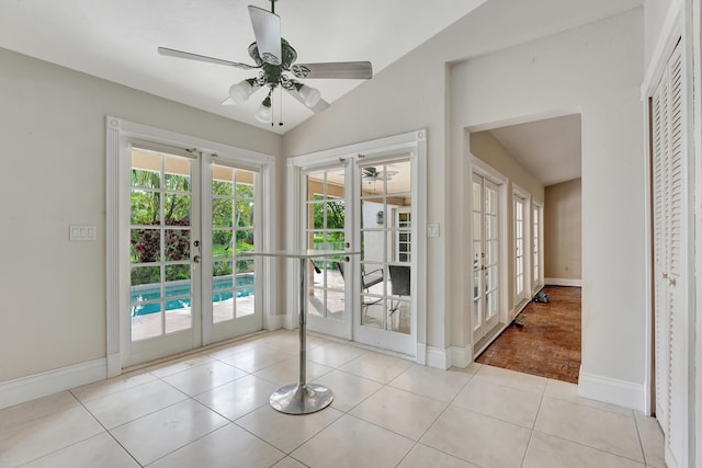 doorway with ceiling fan, light tile patterned floors, french doors, and vaulted ceiling