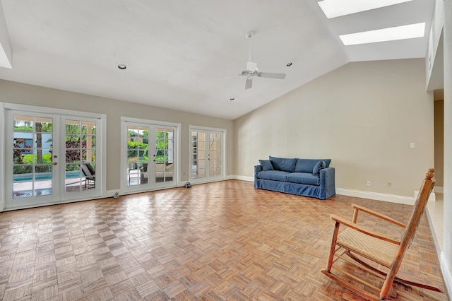 unfurnished room featuring french doors, ceiling fan, light parquet flooring, and lofted ceiling with skylight