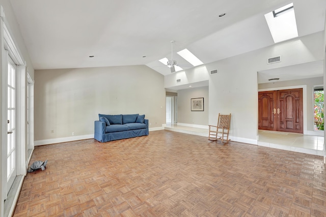 unfurnished room with light parquet floors, ceiling fan, and lofted ceiling with skylight