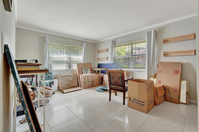 sitting room with plenty of natural light, light tile patterned floors, and crown molding