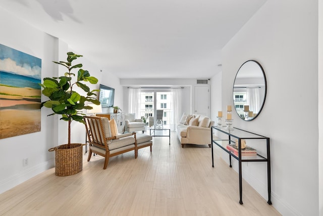 sitting room with light hardwood / wood-style floors