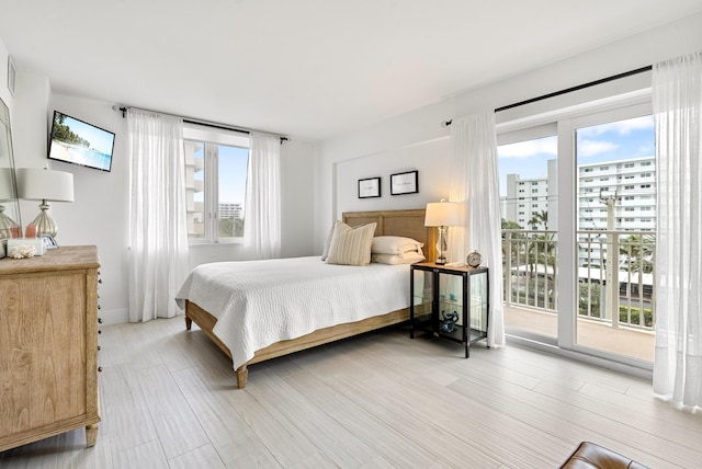 bedroom featuring hardwood / wood-style flooring and access to outside