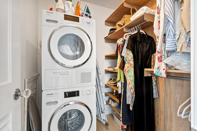 laundry area featuring stacked washer / drying machine