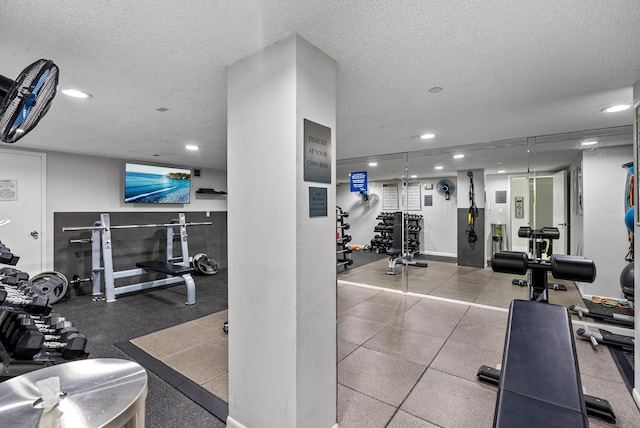 gym featuring a textured ceiling