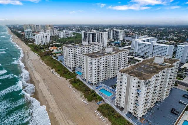 birds eye view of property with a water view and a view of the beach