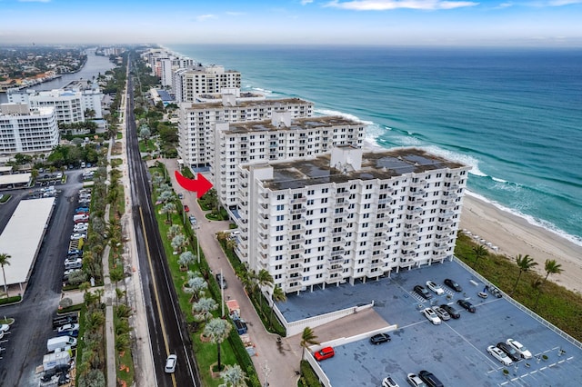 aerial view with a water view and a view of the beach