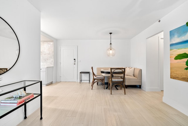 dining space with light wood-type flooring