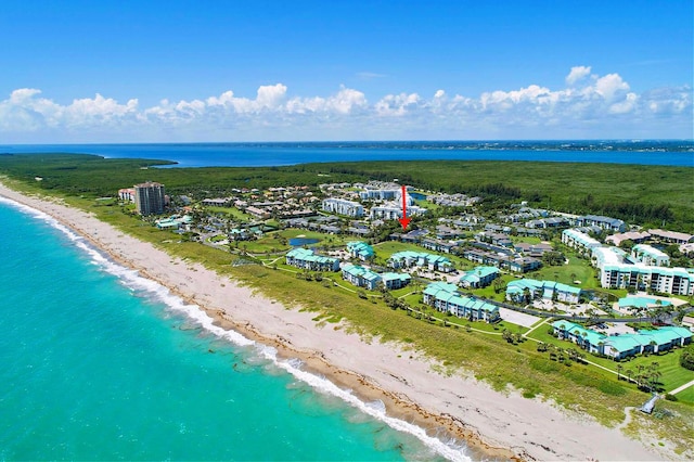 bird's eye view with a water view and a beach view