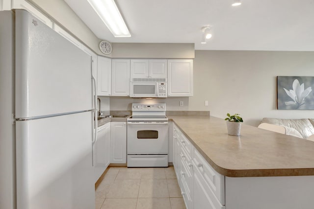 kitchen with white appliances, open floor plan, a peninsula, white cabinetry, and light tile patterned flooring